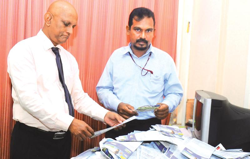 Shantha Jayamaha (Manager Publicity) and Roy Jayasinghe ( Manager Advertising Supplement ANCL) picking the  winning  coupons at  the 11th week  draw.