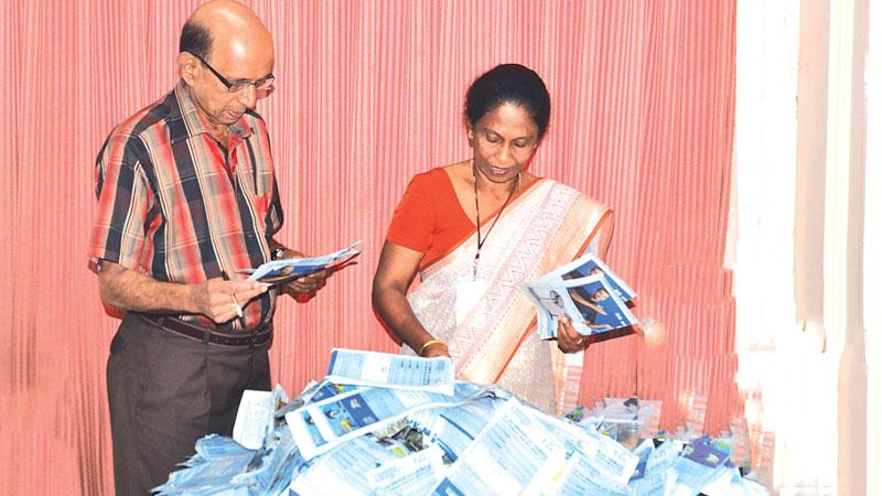 S.Anandakumar (Deputy Editor, Sunday Observer) and B.P. Pushpika (Chief Administrative Officer, ANCL) pick the reader’s prize winning coupons at the end of the 12th week count. Pic. Vipula Amarasinghe