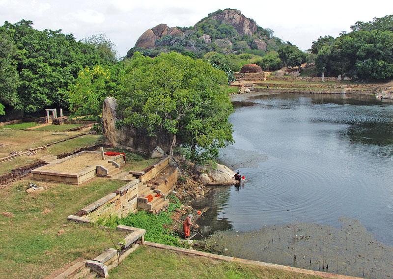 The Kaludiya Pokuna and the view of the monastic complex surrounding the pond. The Rajagirilena hill stands in  the background.