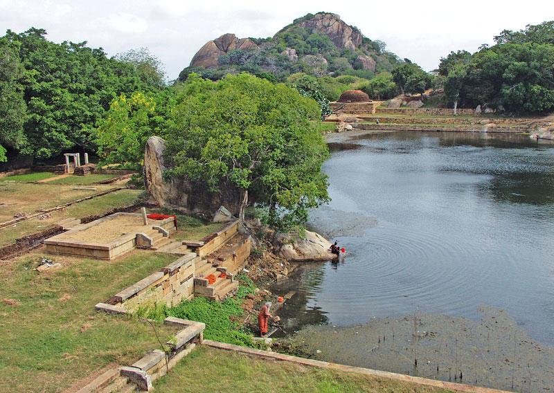 The Kaludiya Pokuna and the view of the monastic complex surrounding the pond. The Rajagirilena hill stands in the background.