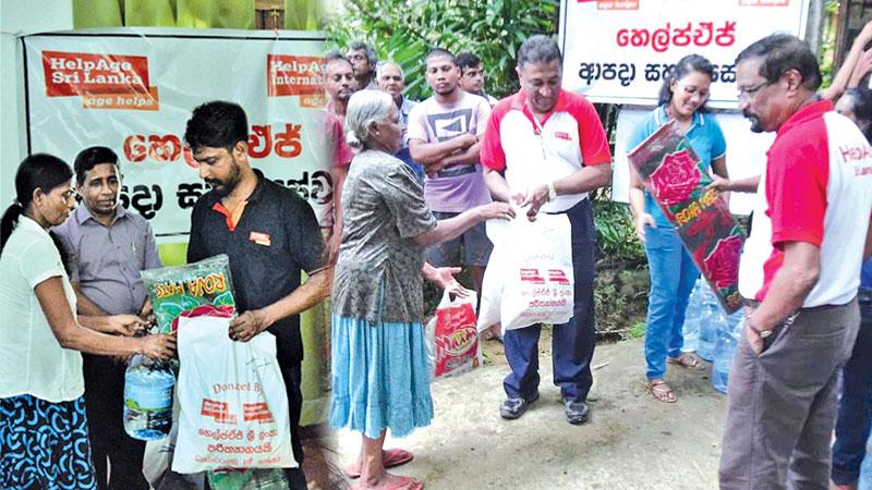 HelpAge Executive Director Samantha Liyanawaduge distributing food items to flood victims . Finance Manager Sumedha Hastanayaka is also in the picture