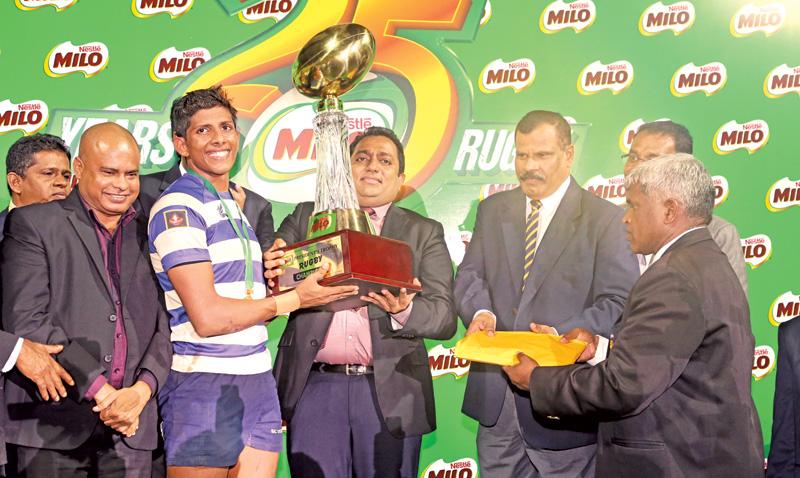 Vinul Fernando Captain of St. Joseph’s College receiving the Millo President’s Trophy from Minster of Education Akila Viraj Kariyawasam after beating Isipathana College 19-13 at the final. Royal College Principal B.A. Abeyratne and other officials are also in the picture.   (Picture Tilak Perera)