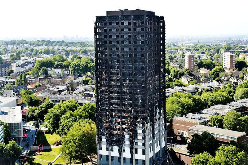 The remains of Grenfell Tower, a residential tower block in west London which was gutted by fire, are pictured against the London skyline on June 16, 2017. The toll from the London tower block fire has risen to at least 30 people dead and the flames have now been extinguished, police said . CHRIS J RATCLIFFE/AFP/Getty Images)