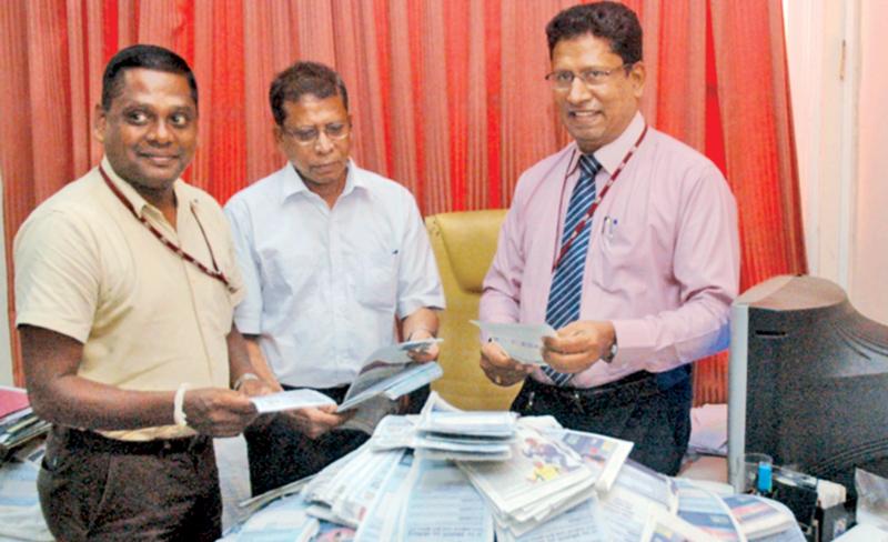 From left: Suresh Dematapitiya (Head of Sales, Lake House Connect (Pvt) Ltd, Ben Roche ( Sub Editor, Sunday Observer) and Chanaka Liyanage (Manager Channel /Publicity) picking the winning coupons.  Pic. Shan Rambukwella