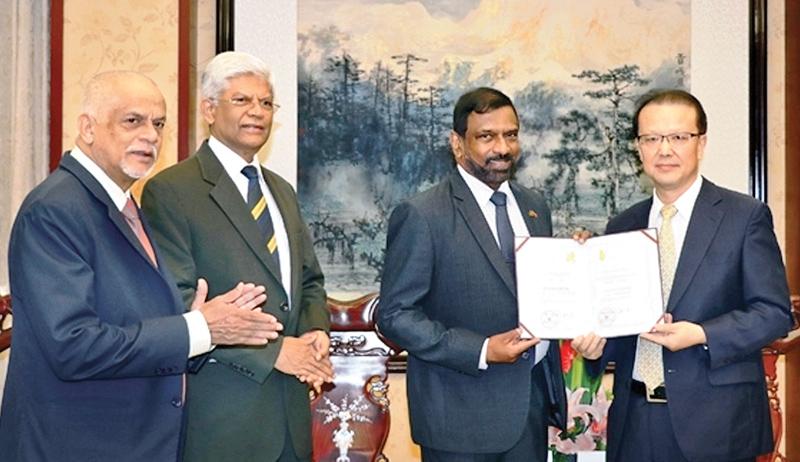 Admiral Dr. Jayanath Colombage receives the Guest Professorship from the Vice President of Sichuan University Professor of Economics Yan Shijing during a ceremony held in Chengdu, attended by Ambassador Bernard Goonethilleke, the Chairman and Luxman Siriwardene, Executive Director of Pathfinder Foundation.