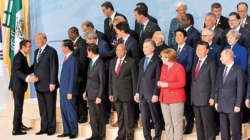 G-20 leaders posed in Hamburg, Germany, on Friday. President Emmanuel Macron of France was with President Trump at left. Pic: The New York Times
