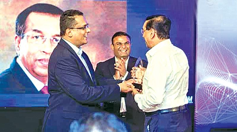 Immediate past Chairman of SLASSCOM Dr. Arul Sivagananathan presenting the award to Jayantha De Silva CEO and President IFS Sri Lanka while  Ruwindhu Peiris, newly appointed Chairman of SLASSCOM looks on