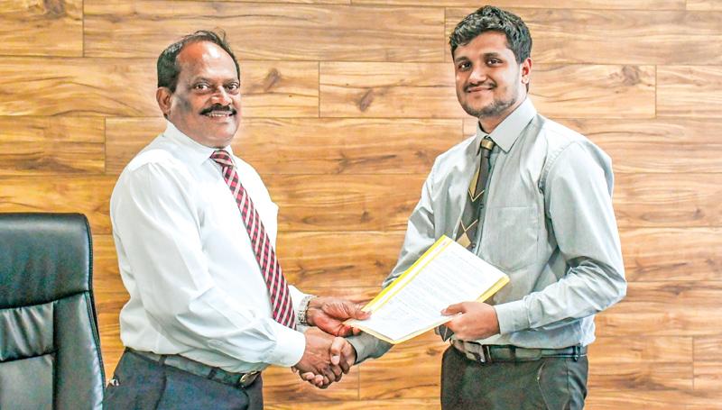 Dr. E. A. Weerasinghe, the Vice Chancellor of NSBM and Jananga Piyadasa, Business Analyst of MTI Consulting exchanging the signed MoUs at the signing ceremony held at NSBM Green University Town, Pitipana, Homagama. 