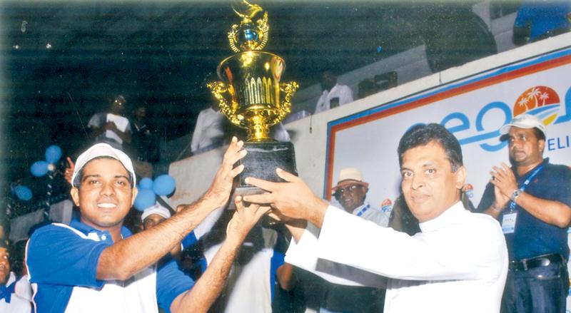 Sajith Kumara skipper of Camelot Beach Hotel receiving the champions Trophy  from chief guest Rev. Fr Jayantha Wicramasinghe.   