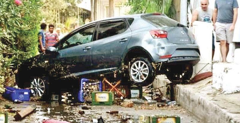 A car left wedged in a street in the Agean coastal city of Mugla following a sea surge caused by the earthquake Pic: Dogan News Agency