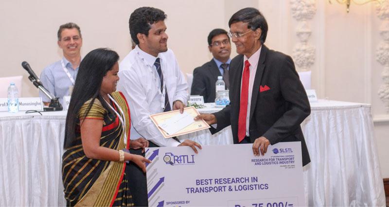 Chief guest Prof. Mohan Munasinghe gives away an award.