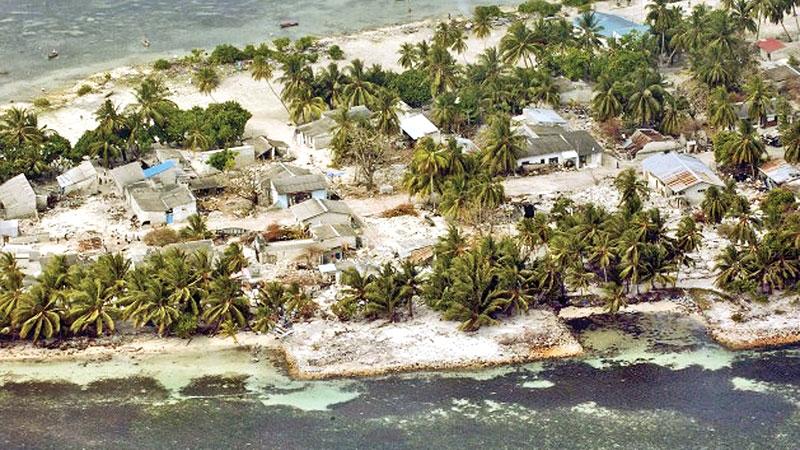 An aerial view of the Village of Kolhuvaariyaafushi, Mulaaku Atoll, the Maldives, after the Indian Ocean Tsunami. Credit: UN Photo/Evan Schneider