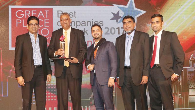 Managing Director Saif Yusoof, Directors Gaazali Arifeen and Ashker Laffir receive the award from Deputy CEO of Huawei Sri Lanka, Vasabha Bulathsinhala.  