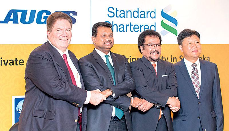Chief Executive Officer of Standard Chartered Sri Lanka, Jim McCabe, Chairman, Laugfs Holdings, W.K.H. Wegapitiya, Group Managing Director of Laugfs Holdings, Thilak de Silva and Deputy General Manager of SINOSURE, Guo Yilin at the ceremony.     