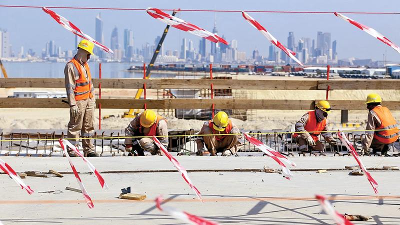 Road to ruin? … labourers at work on the Sheikh Jaber Al-Ahmad Al-Sabah causeway in Kuwait City in February. Pic: Yasser Al-Zayyat/AFP/Getty    
