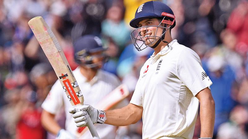 England's Alastair Cook celebrates reaching 200 during play on day 2 of the first Test cricket match between England and the West Indies at Edgbaston in Birmingham, central England on August 18. AFP