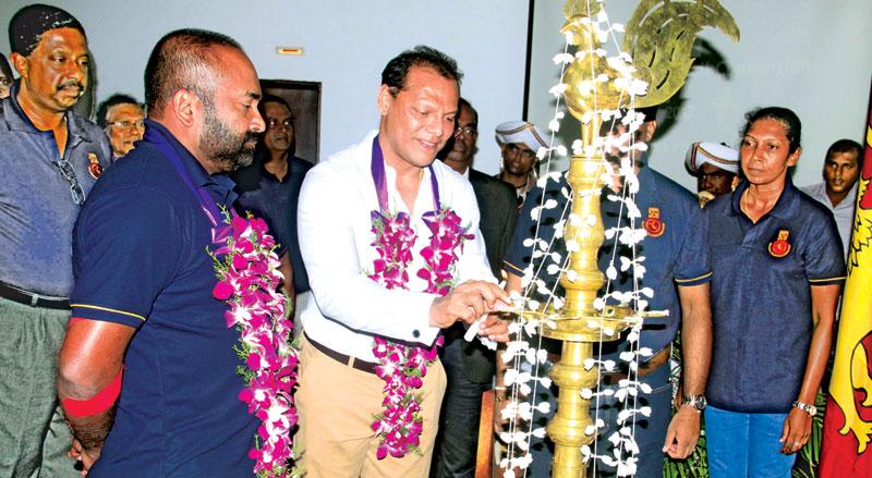 Minister of Sports Dayasiri Jayasekera lighting the traditional oil lamp to commence the National Volleyball Convention with Minister of Power and Renewable Energy and President SLVBF, Ranjith Siyambalapitiya (on left) also present.