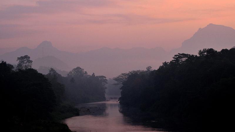 A breathtaking view of sunrise at the dawn over Yatiyantota mountain ranges, seen through the valley of Kelani Ganga at Karawanella.