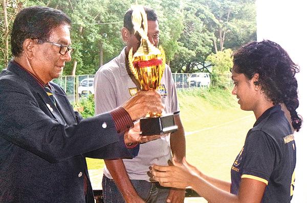 Manager of the Palinks Cricket team, Palitha Gunasekera awarding the Runners-up trophy to Udara Bandara Captain of Mahamaya Girls College.