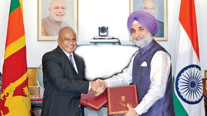 High Commissioner of India to Sri Lanka Taranjit Singh Sandhu (r) and Secretary, Ministry of Education Sunil Hettiarachchi exchanging the MoU to renovate Saraswathy Central College, Pusselawa located in Kandy District of Sri Lanka.      