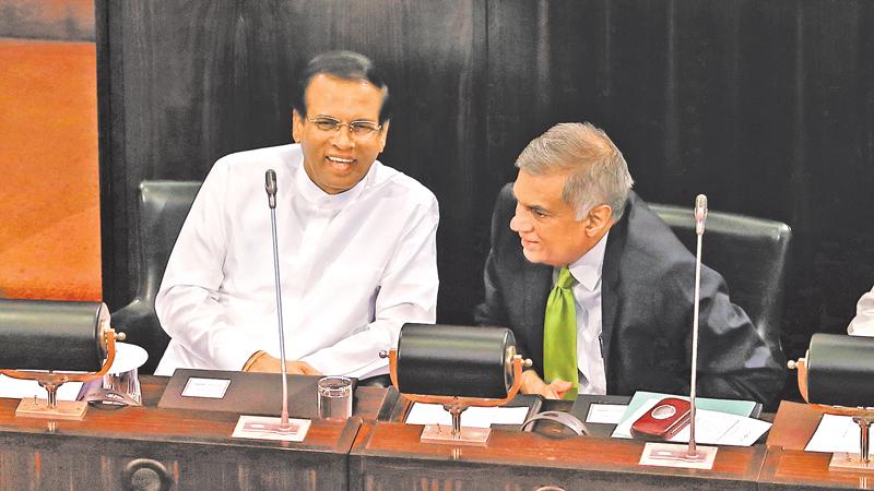 President Maithripala Sirisena and Prime Minister Ranil Wickremesinghe share a light moment during a special session to commemorate the 70th anniversary of Parliament last week. Pic: Thilak Perera