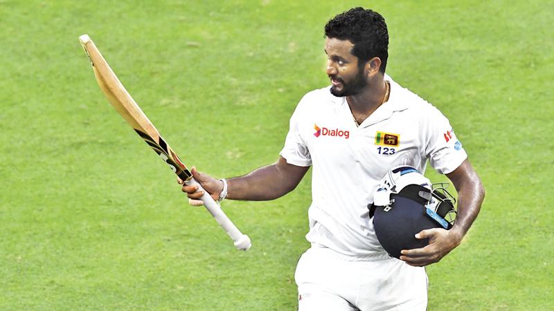 Dimuth Karunaratne of Sri Lanka leave the field after being dismissed by Wahab Riaz of Pakistan during the second day of the second Test cricket match between Sri Lanka and Pakistan at Dubai International Stadium in Dubai on October 7, 2017.  - AFP PHOTO