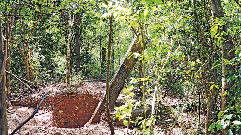 Vandalism: the hole dug to remove  a stone pillar by treasure hunters 