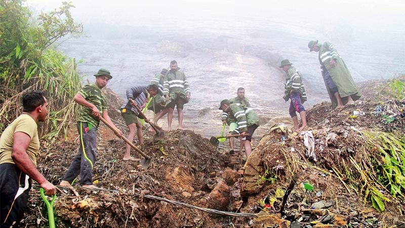 Sri Lanka Army’s 3rd Battalion of the Sinha Regiment and the Sri Lanka, National Guard were left to deal with clearing up the garbage and the debris. (Pix: Ranga Udugama)