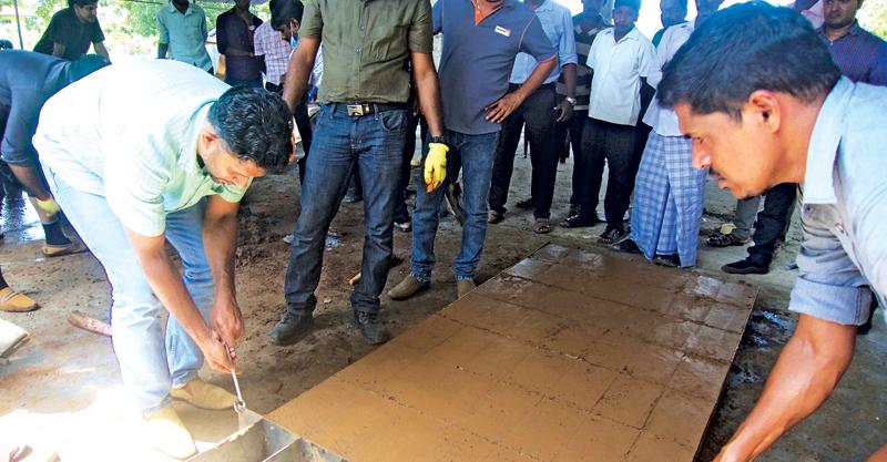 Prof. Rangika Halwathura removing the moulded bricks 