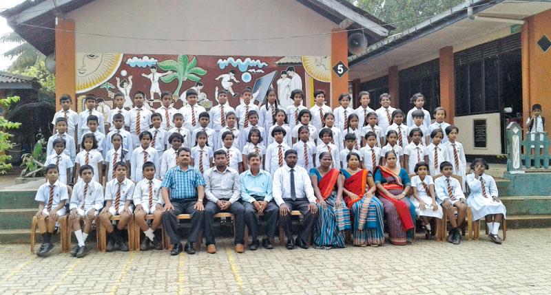 The 56 students of Ovitigama Primary School, Pugoda who were successful in the  Grade 5 Scholarship Examination with their teachers.  