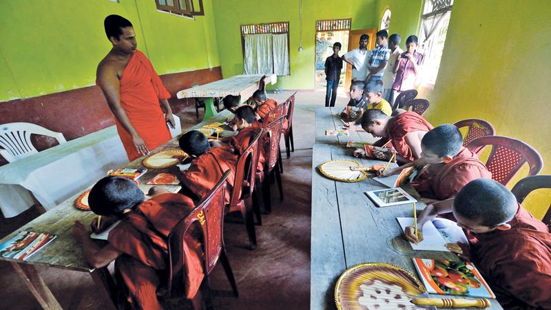 At an elevation of over a thousand metres at the Batatota cave temple in the outskirts of Eratna, a group of student Samanera Bhikkus learn English at a newly set up English medium Pirivena.   