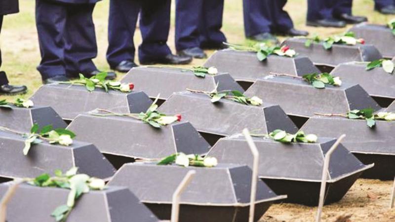 The coffins carrying the remains of 77 unknown German soldiers from WWII are seen during a reburial ceremony at Germany’s largest military cemetery in the east German town of Halbe on Nov. 4, 2011. (Pic: Patrick Pleul, AFP/Getty Images)