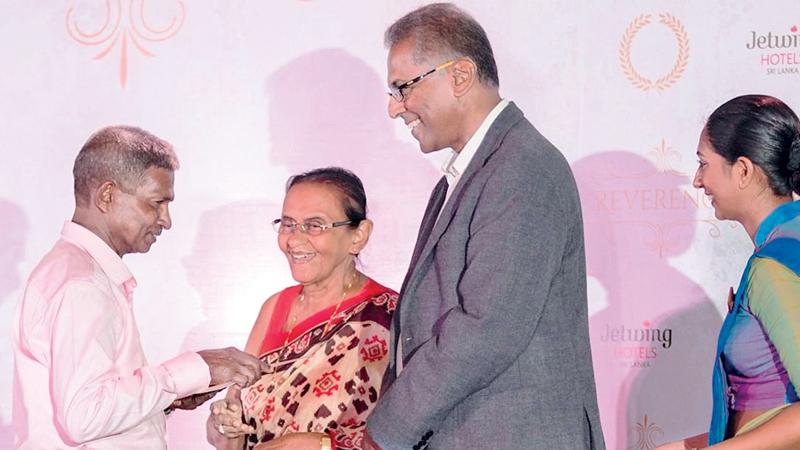 Josephine Cooray and Hiran Cooray presenting an award to a senior associate