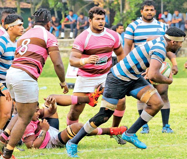 Navy’s Lahiru Herath breaks off from the Havelocks defense in the Dialog ‘A’ division rugby encounter at Welisara yesterday. Navy beat Havies 25-14 .Pic: Sudam Gunasinghe