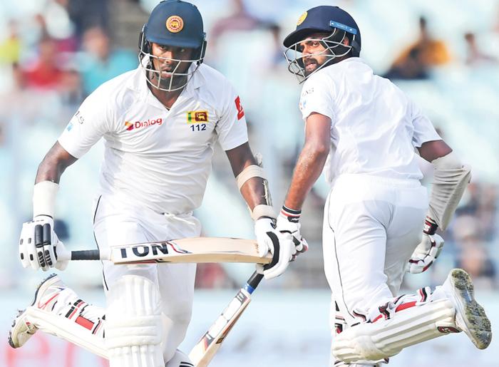 Sri Lanka’s Angelo Mathews (L) and Lahiru Thirimanne run between the wickets during the third day of the first Test between India and Sri Lanka at the Eden Gardens cricket stadium in Kolkata. - AFP