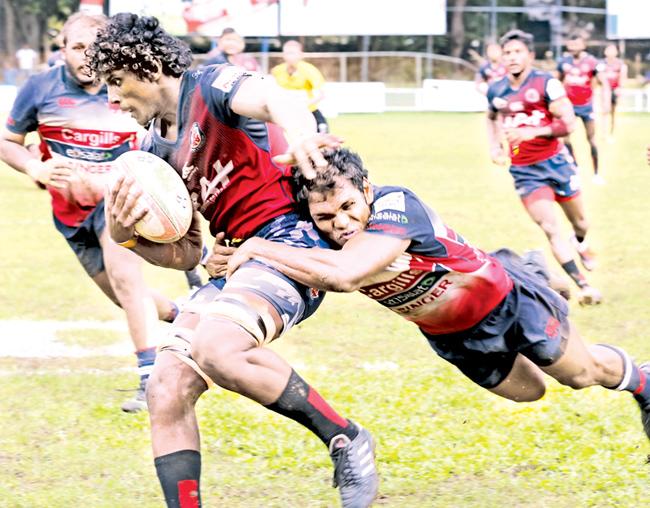 Kandy SC’s  Fazil Marija tackling a CR&FC player during  their  Dialog A division   rugby match at Longden  Place  yesterday.     Pic. Chinthaka Kumarasinghe 