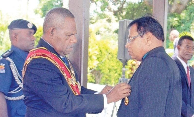 P.M.N. Bandara (on right) receiving the honours from the Governor General of Papua New Guinea Grand Chief Sir Bob Dadaeat