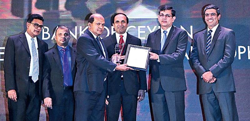 The Bank of Ceylon’s Non-Executive Director and Audit Committee Chairman Ranel T. Wijesinha (left) and the Deputy General Manager Treasury,  Investment and International/ Chief Financial Officer Russel Fonseka  (middle) receive the award from Vice President of CA Sri Lanka,    Jagath Perera.  