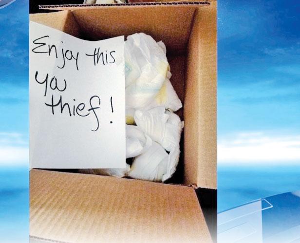 A box filled with dirty diapers and a note for a package thief 