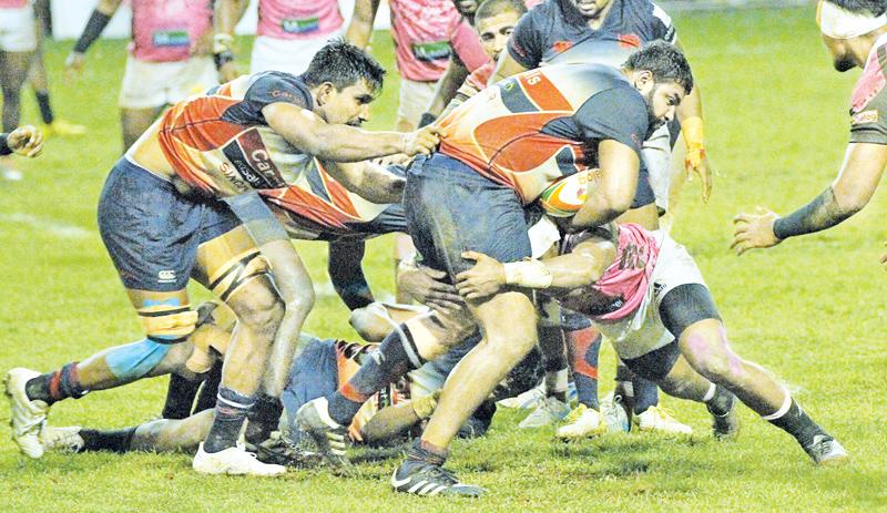 A tussle for the ball in the Dialog ‘A’ division rugby match between defending champs Kandy SC and Havelocks SC at Havelock Park under lights yesterday. (Pic by Sudam Gunasinghe)