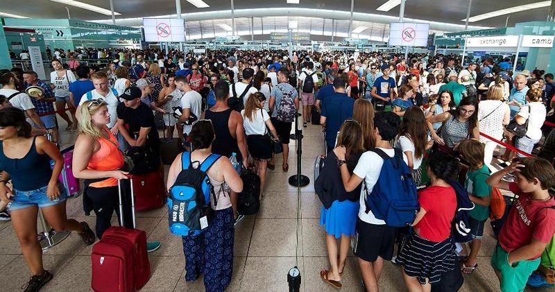 Travellers queue at the security checkpoints at Barcelona-El Prat airport, Spain. Pic: Alejandro Garcia/EPA   