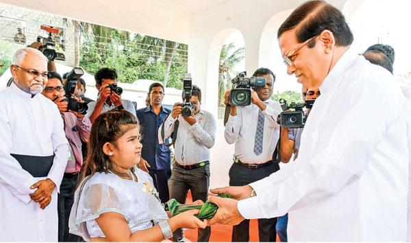 President Maithripala Sirisena being welcomed by a child at the State Christmas Festival held at the Hindu Cultural Centre, Trincomalee.