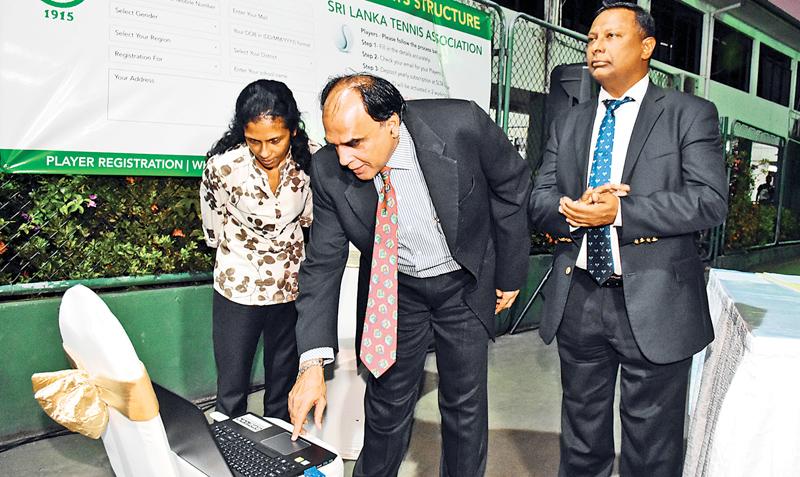 President of the Sri Lanka Tennis Association launching the website for the SLTA watched by Suresh Subramaniam and Zarina Raheem.  