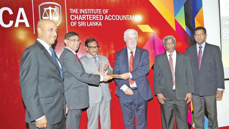 CA Sri Lanka President elect Jagath Perera presents a copy of the Code to Prof. Barry J. Cooper. Lasantha  Wickremasinghe, Asite Talwatte, Aruna Alwis and Prof. Gishan Dissanaike (of the University of Cambridge) look on.   