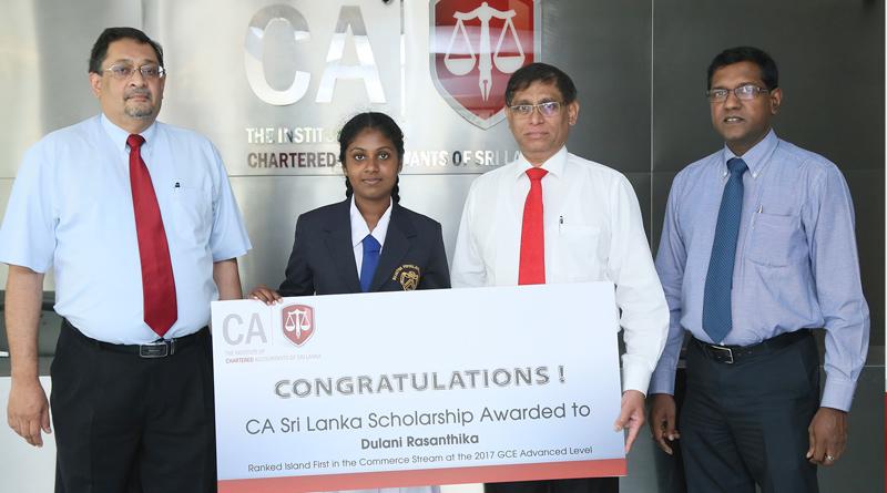 CA Sri Lanka President Jagath Perera presents the scholarship to Ms. Dulani Rasanthika of Sujatha Balika Vidyalaya, Matara, who was adjudged all-island first in the commerce stream at the 2017 GCE Advanced Level exam. Also in the picture are CA Sri Lanka’s Vice President Manil Jayesinghe and CEO Aruna Alwis.