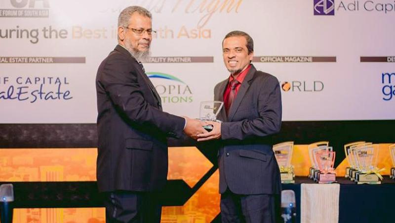 Head of Islamic Banking, Hisham Ally receives the award from Chief Executive Officer, ADL Capital, Ishrath Rauf.    