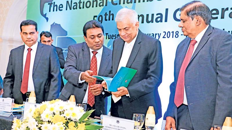 Prime Minister Ranil Wickremesinghe browses through a souvenir. PIC: HIRANTHA GUNATHILAKA