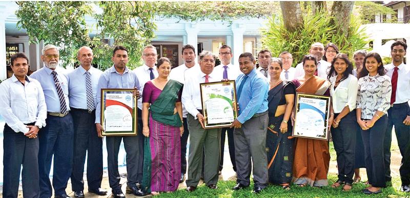 CCC CEO Sanith de Silva Wijeyeratne hands over certificates to MRH Managing Director Jayantha Panabokke, with the Senior Management Teams of MRH, CCC and SFG in the background