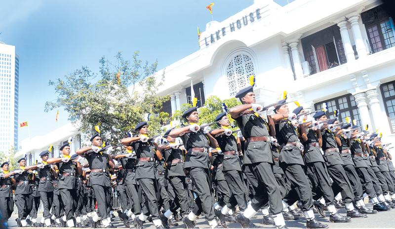 Pic: Wimal Karunatilake 70th Independence Day celebrations: Soldiers march in front of the Lake House building during the full dress rehearsal last Friday