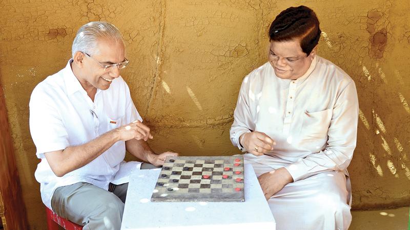 State Minister Finance Eran Wickramaratne and Joint Opposition MP Bandula Gunawardena were seen engaged in a friendly game of Checkers at the first ‘Love Sri Lanka Festival’ held at the Viharamahadevi Amphitheatre yesterday.  Pic: Shan Rupassara